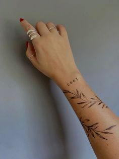 a woman's hand with a small tattoo on her left wrist and the word cool written in cursive writing