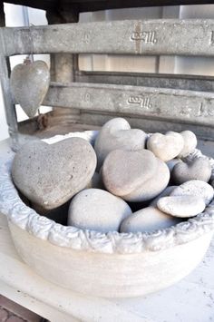 a bowl filled with rocks sitting on top of a table