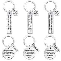 four key chains with different sayings on the front and back of each one,