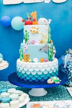 a blue and white cake sitting on top of a table