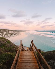 a wooden walkway leading down to the beach