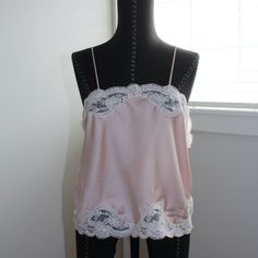 Description: Christian Dior Pink Blush Lace Cami Slip Tank: Timeless Elegance Meets Vintage Allure In This Delicately Crafted Cami Slip Tank. Adorned With Intricate Lace Detailing, It Exudes Femininity And Sophistication, Adding A Touch Of Vintage Charm To Your Wardrobe. Color: Light Pink & White Lace Size: Large Condition: Good Attached With Original Christian Dior Tag, Small Stain In The Front Of Garment Fabric: 100% Polyester Measurements (Inches Laid Flat): Bust: 19.0" Length: 20.0" At Aprs Elegant Pink Camisole For Daywear, Feminine White Silk Camisole, Feminine Wedding Camisole, Feminine Silk Camisole For Wedding, Silk Feminine Camisole For Wedding, Vintage Cami Top, Vintage Cami, Dior Top, Dior Pink