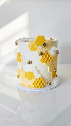 a white and yellow cake with honeycombs on it