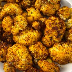 a white plate topped with cauliflower covered in seasoning