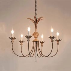 a wooden chandelier with five lights hanging from it's center and four arms