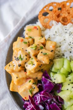 a plate filled with rice, meat and veggies