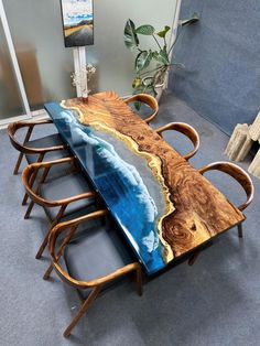 the table is made out of wood and has an ocean scene painted on it's surface