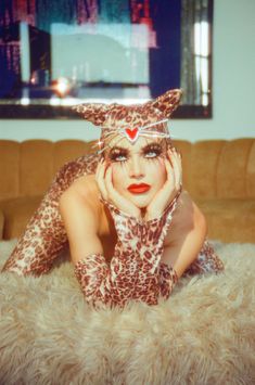 a woman laying on top of a fur covered floor