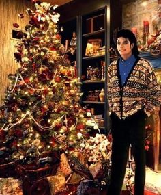 michael jackson standing in front of a christmas tree