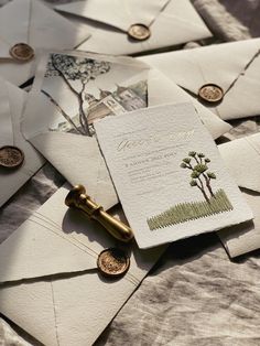 several envelopes are laying on top of each other with wax stamp and some coins