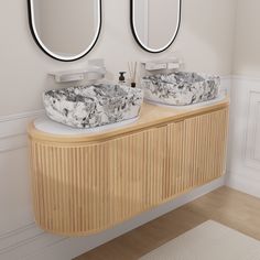 two round mirrors are on the wall above this double sink vanity in a white and wood bathroom