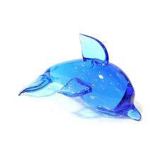 a blue glass dolphin figurine on a white background