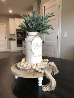 a vase with some plants in it on a table