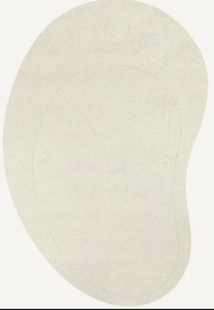 an oval shaped white rug on a white background