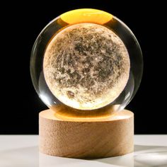 a glass ball sitting on top of a wooden stand