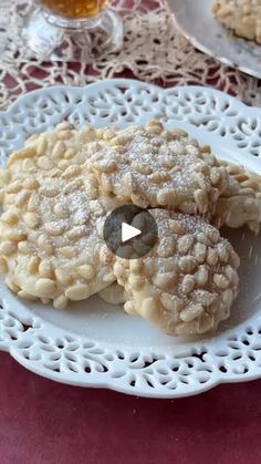 two cookies on a white plate next to a glass of beer