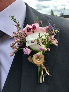 a boutonniere with pink and white flowers is worn on a man's lapel