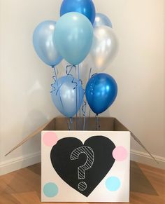 a box with balloons and a question mark drawn on it