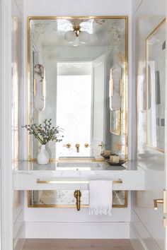 the instagram page shows an image of a white bathroom with gold trim and mirrors