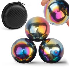 three shiny balls in front of a black case