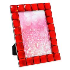 a red and white photo frame sitting on top of a table