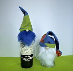 two gnomes are next to a bottle of wine