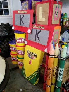 crayons are stacked on top of each other in front of the letter k