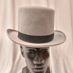 Broadway Quality, Made In Usa, 100% Wool Top Hat. Crown: 5-Inch High / Brim: 2-Inch Wide. This Is The Perfect Moderately Priced Top Hat Without The Cheap Look. This Hat Is Often Worn For Formal Wear Events. Color: Black, Brown, Gray American / Nearest 1/8 Inch / Metric Cm / Size Code 6 3/4 21 1/8 54 Small 6 7/8 21 1/2 55 Small / Child L 7 1/2 23 1/2 60 X-Large 7 5/8 23 7/8 61 X-Large These Hats Are Of High Quality And No Longer Manufactured So The Sizes And Quantity Available Are Finite. We Classic Gray Flat Brim Hat, Classic Gray Hat Bands With Flat Brim, Classic Gray Brimmed Hat, Classic Gray Hat With Short Brim, Classic Short Brim Winter Costume Hat, Classic Gray Flat Brim Hat Band, Classic Gray Fedora Hat, Classic Short Brim Costume Hat For Winter, Adjustable High Crown Hats For Winter