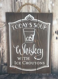 a wooden sign that says today's soup whiskey with ice croutons