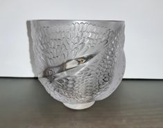 a glass bowl with a spoon in it on a table