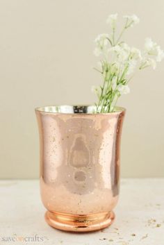 a vase with flowers in it sitting on a table