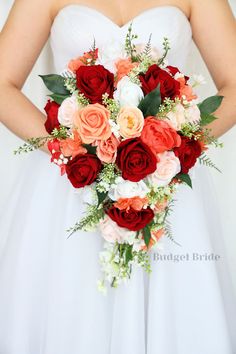 a bridal holding a bouquet of red and orange flowers