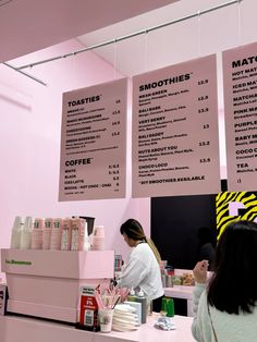 the menus are hanging above the counter for customers to order at their eatery