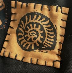 a close up of a piece of cloth with a design on it and an image of a spiral in the center