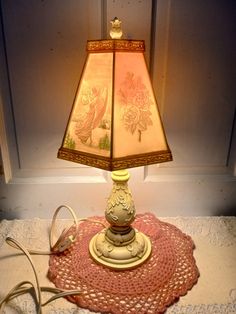 a lamp that is on top of a doily