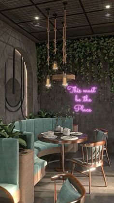 the interior of a restaurant with plants growing on the wall and tables in the middle