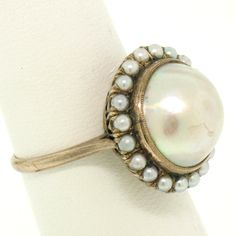 You are looking at a beautiful, antique, mabé pearl ring & earrings set. The set is crafted in solid 10k rose gold and it still has its original patina preserved which can be polished to like new if desired. The design shows the mabé pearl bezel set in the center of the setting surrounded with a prong set seed pearl bezel on all 3 pieces. We can sell you any piece individually if you desire. Enjoy! -- Item Details -- Material: 10k Solid Rose Gold Weight: 18.3 Grams -- Stone(s): (3) Natural G Antique Round Jewelry With High Luster, Vintage Pearl Drop Jewelry For Anniversary, Vintage Domed Jewelry For Wedding, Antique Round High Luster Jewelry, Vintage Oval Pearl Ring Stamped 14k, Victorian Pearl Drop Jewelry For Anniversary, Victorian Cabochon Jewelry For Wedding, High Luster Vintage Ring Jewelry, Antique High Luster Round Jewelry