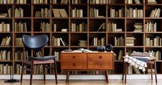 a chair and desk in front of a bookshelf