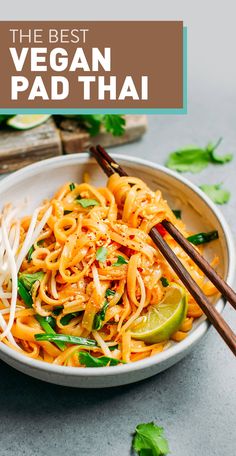 the best vegan pad thai noodles in a white bowl with chopsticks and cilantro