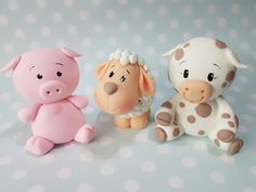 three toy animals sitting next to each other on a table