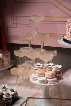 a table topped with lots of cupcakes next to cakes and desserts on plates