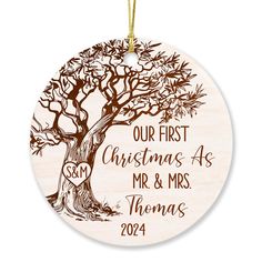 a wooden ornament with a tree on it that says our first christmas as mr and mrs thomas