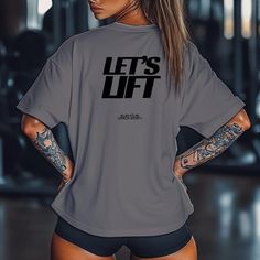 Ready to make a statement in the gym? Our "Let's Lift" unisex gym shirt is designed for those who take their workouts seriously and want to show it. Whether you're pushing through a tough lift or motivating yourself for that next set, this shirt embodies the spirit of hard work, dedication, and strength. - Unisex Fit: Designed to look great on both men and women. Available in a range of sizes to ensure the perfect fit for everyone. - Premium Quality Fabric: Made from a high-quality cotton-polyester blend, ensuring comfort, breathability, and durability. Perfect for intense gym sessions or casual wear. - Perfect for All Workouts: Whether you're lifting, doing cardio, or hitting your favorite group class, this shirt will keep you comfortable and motivated. Make every rep count in style. Grab Gray Athleisure T-shirt With Letter Print, Gray Sportswear T-shirt For Gym, Gray Short Sleeve Activewear For Gym, Gray Relaxed Fit Workout Tops, Gray Relaxed Fit Top For Gym, Short Sleeve Squat Proof Activewear For Gym, Squat Proof Short Sleeve Activewear For Gym, Logo Print Gym Tops, Gray Sportswear T-shirt With Letter Print