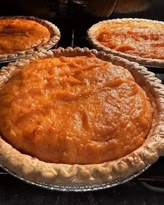 three pies sitting on top of an oven rack