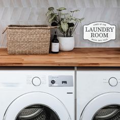 a washer and dryer sitting next to each other on top of a wooden counter