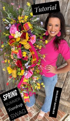 a woman standing next to a wreath with flowers