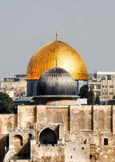 an old building with a golden dome in the middle of it's roof area