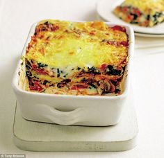 two white plates topped with lasagna casserole