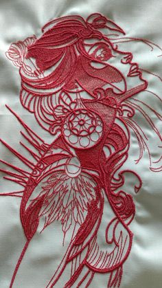 red embroidery on white fabric with dragon design