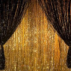 an image of a curtain with gold sequins on the side and black curtains behind it